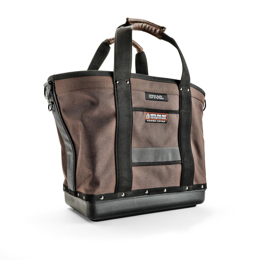 A durable Cargo Tote by VET, featuring a rugged brown and black design, reinforced handles, and metal studs on the bottom.