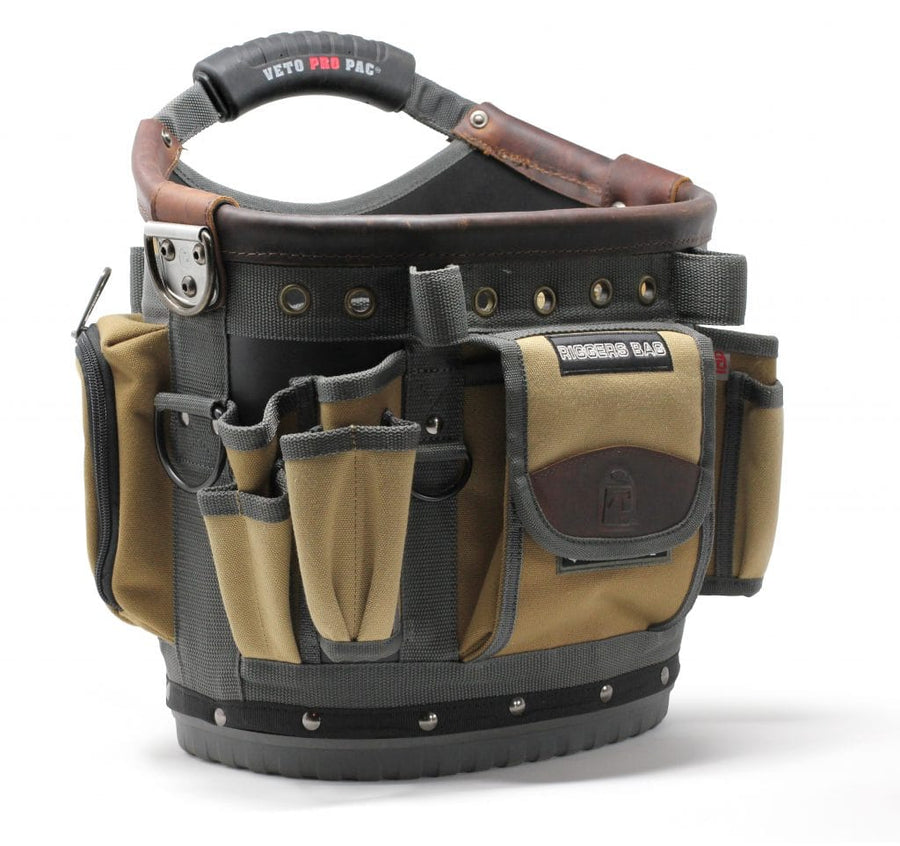 A tan and black VET Riggers BAG with multiple tool pockets, compartments, a sturdy handle, and a label. The empty bag stands upright.