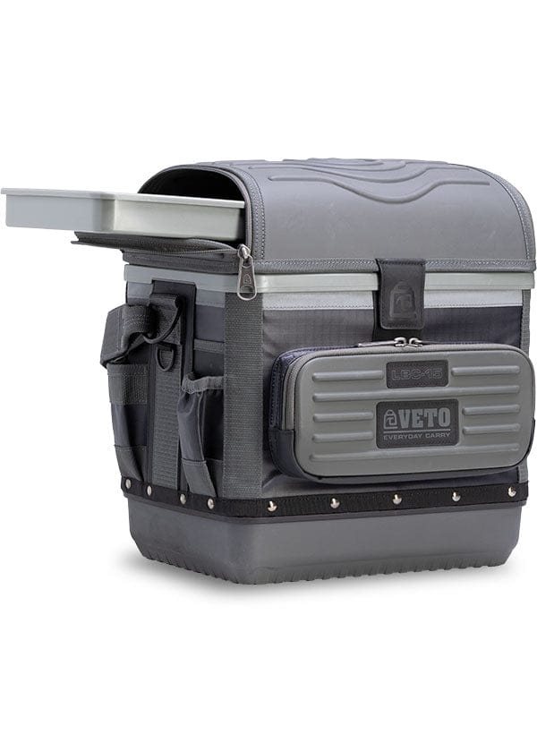 The Veto Pro Pac Cooler by VET is a gray utility storage box with multiple compartments, side pockets, and a magnetic latch for secure closure. With its compact, lunchbox-sized design labeled "VETO," it's perfect for organizing essentials on the go.