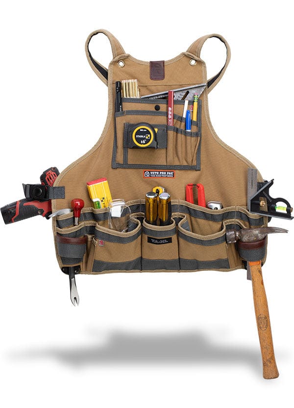 The VET Veto Tool Apron is crafted from durable polyester canvas and includes chest pockets designed to organize a variety of tools such as a hammer, pliers, measuring tape, screwdrivers, and pencils.