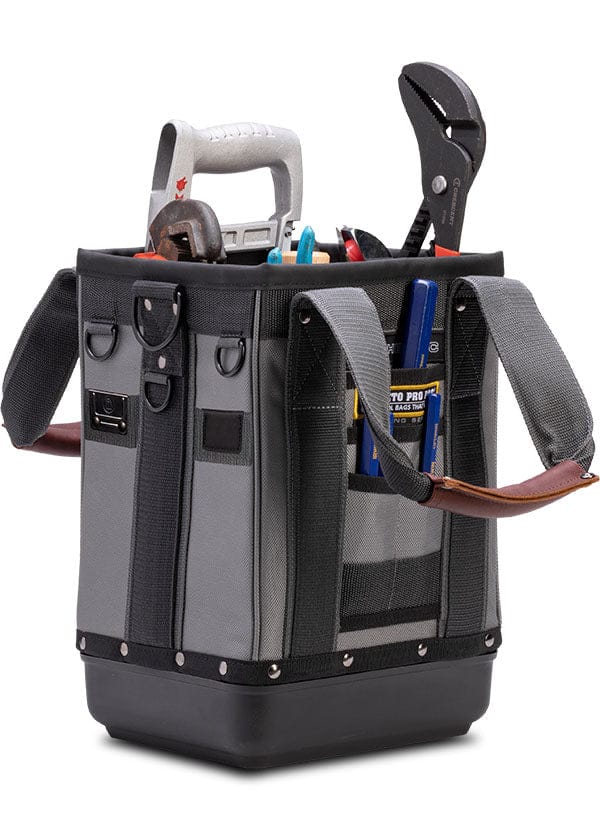 The WRENCHER-MC by VET is a sleek gray and black vertical tool bag with handles, customizable storage pockets, and includes a wrench and screwdriver set, making it the ideal companion for any handyman on the go.