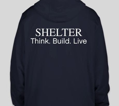 The black Shelter Sport-Tek Pullover Sweatshirt by Custom Ink features "SHELTER Think. Build. Live." in white text on the back with the Shelter Logo, offering supreme comfort with its lightweight performance fabric, ideal for adventures or casual days.
