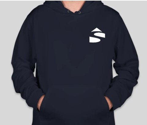 A person is wearing a Custom Ink Shelter Sport-Tek Pullover Sweatshirt in black with a white geometric logo on the chest, crafted from lightweight performance fabric. Their hands are in the front pocket against a gray background.