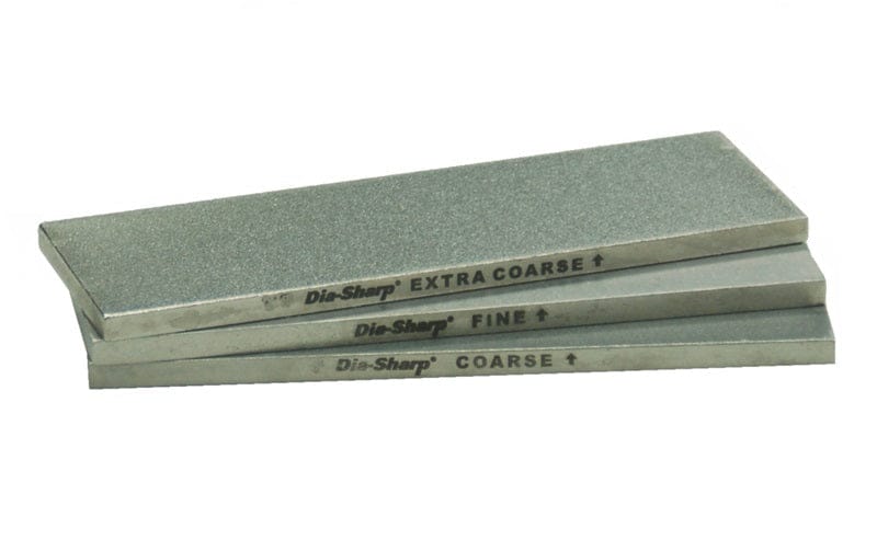 Three rectangular DMT Dia-sharp Diamond Bench Stone 6-in stones—EXTRA COARSE, FINE, and COARSE—are stacked with visible labels, displaying a grit guide and continuous diamond surface for precise sharpening.