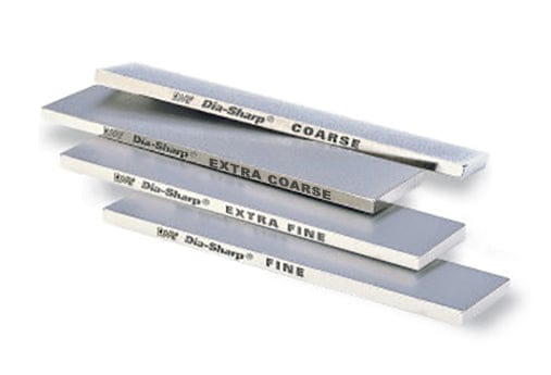 Four DMT Dia-Sharp Diamond Bench Stone 11-in sharpeners are stacked in a staggered layout, each labeled coarse, extra coarse, extra fine, or fine. The metallic surfaces have a continuous diamond surface that reflects light.