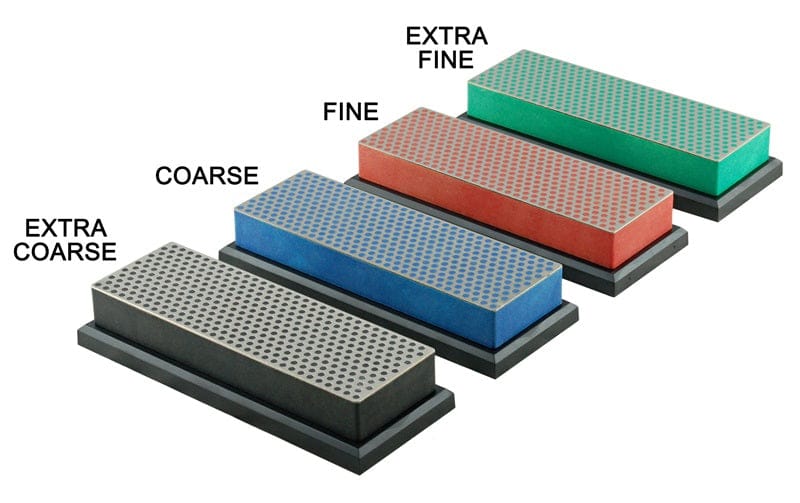 The DMT Diamond Whetstone Bench Stones 6-inch set includes four rectangular sharpeners—extra coarse, coarse, fine, and extra fine—each with a unique color and grid pattern, arranged in order from roughest to smoothest.