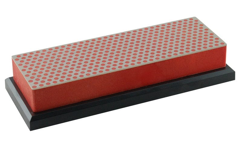 The DMT Diamond Whetstone Bench Stones 6-inch features a rectangular design with a red base and a surface of silver and red circular dots, displayed on a black platform.