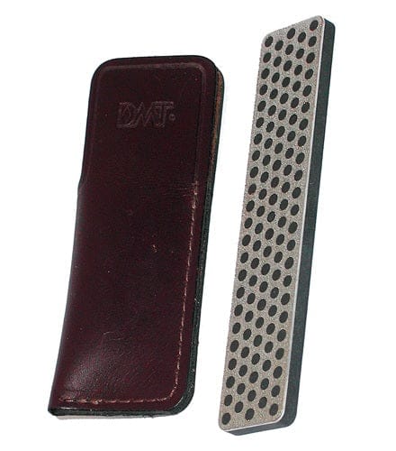 A DMT Diamond Whetstone with Sheath, featuring a 4-inch sharpener with a black and gray grid pattern, rests next to its closed dark brown leather case, highlighting its durable construction.