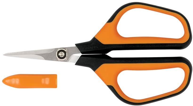 A pair of Fiskars Micro-Tip Pruning Snips with orange handles and a pointed tip, featuring stainless steel blades, shown alongside its matching orange protective cover.
