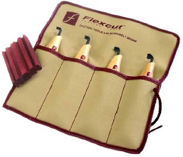 The FLE 4 Piece Scorp Carving Set Right Handed features four wood carving gouges with wooden handles in a tan and maroon roll-up pouch, shown next to a red sharpening compound for your strop.