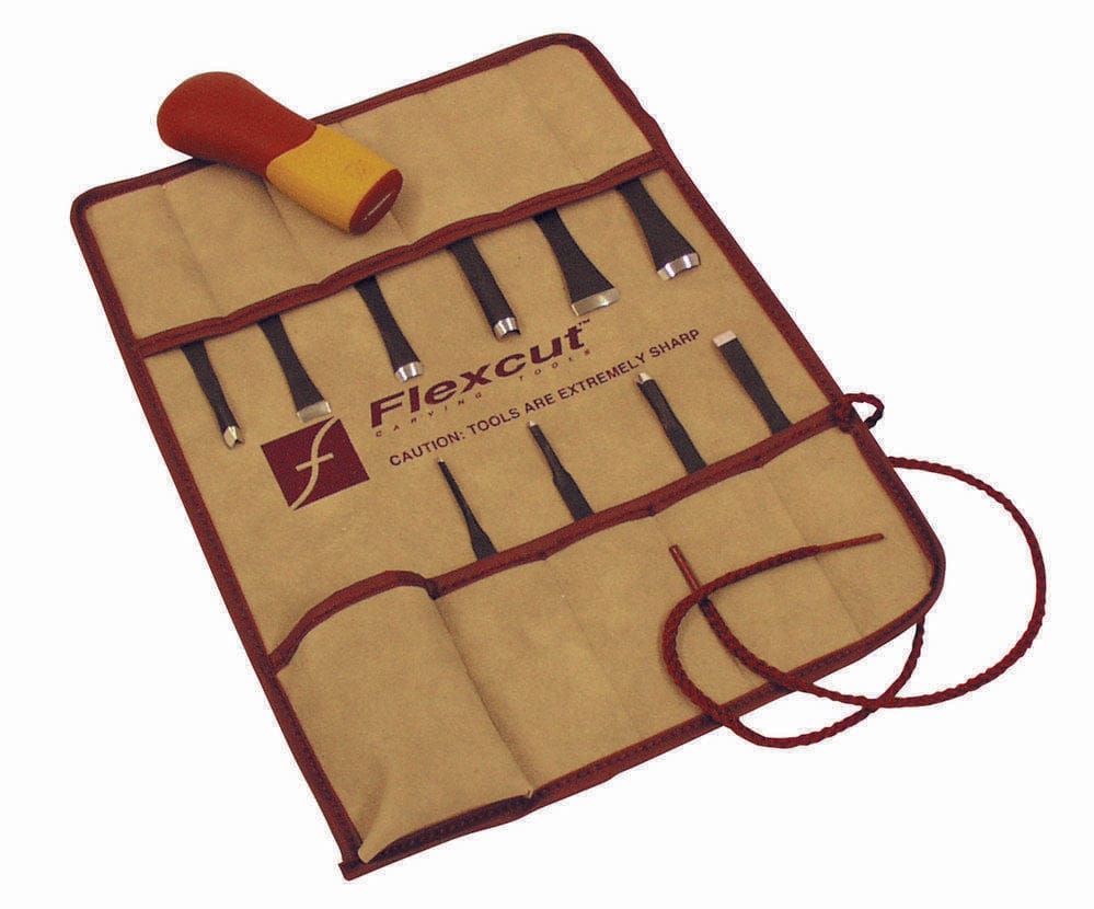 The FLE Craft Carver Set 11-Piece comes neatly organized in a tan roll-up pouch. Be cautious of the warning label on these sharp tools.