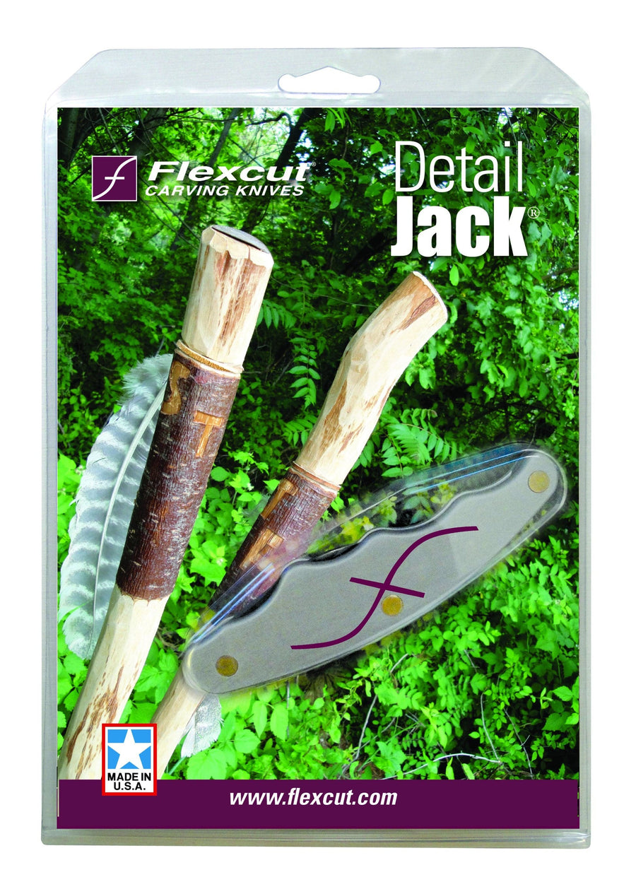 The FLE Detail Jack carving knife is showcased with its ergonomic handle alongside carved wooden sticks and a leaf in the background.