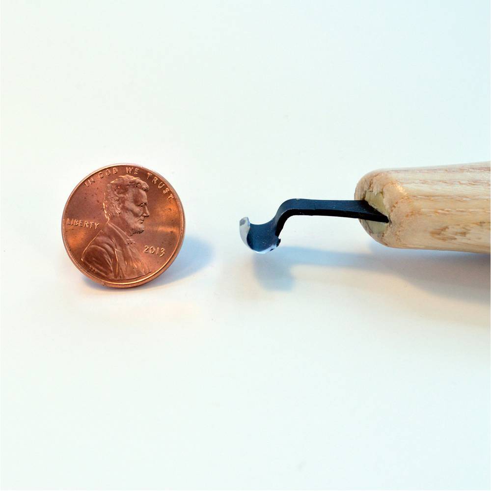 A 2013 penny rests next to the FLE Right Scorp 3/16-in, a small wood-handled tool ideal for hollowing cavities, on a light surface.