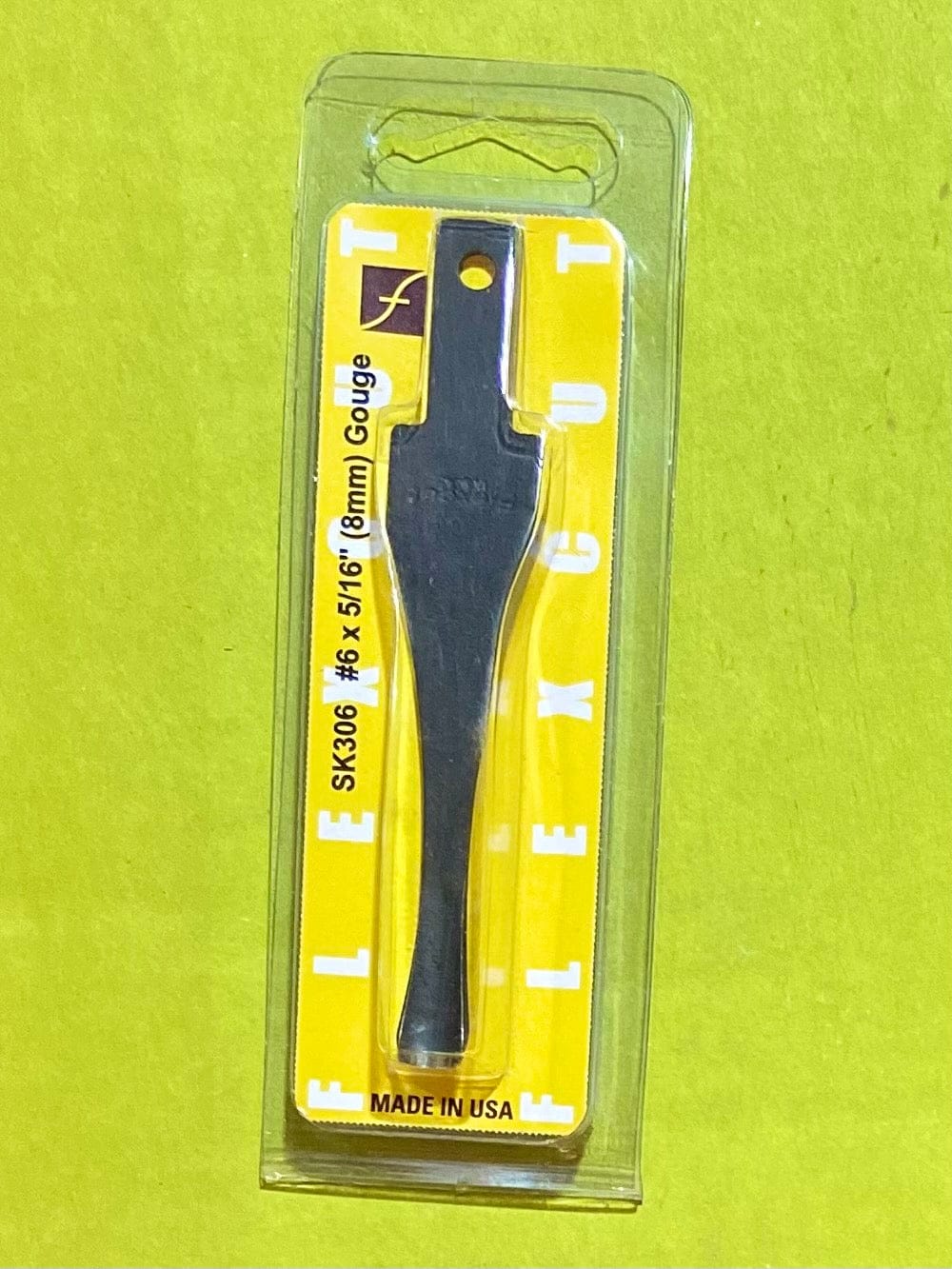 A FLE Flexcut Gouge Blade, SK306 #6 x 5/16 (8mm), comes in yellow plastic packaging with white text and a Flexcut logo, labeled Made in USA.