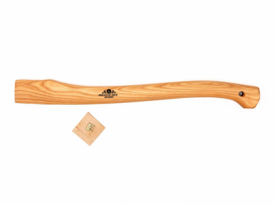 The GRF Grans Forest Small Forest Axe Handle with ergonomic hickory design and end hole is shown next to a small wooden wedge, both displayed on a white background.