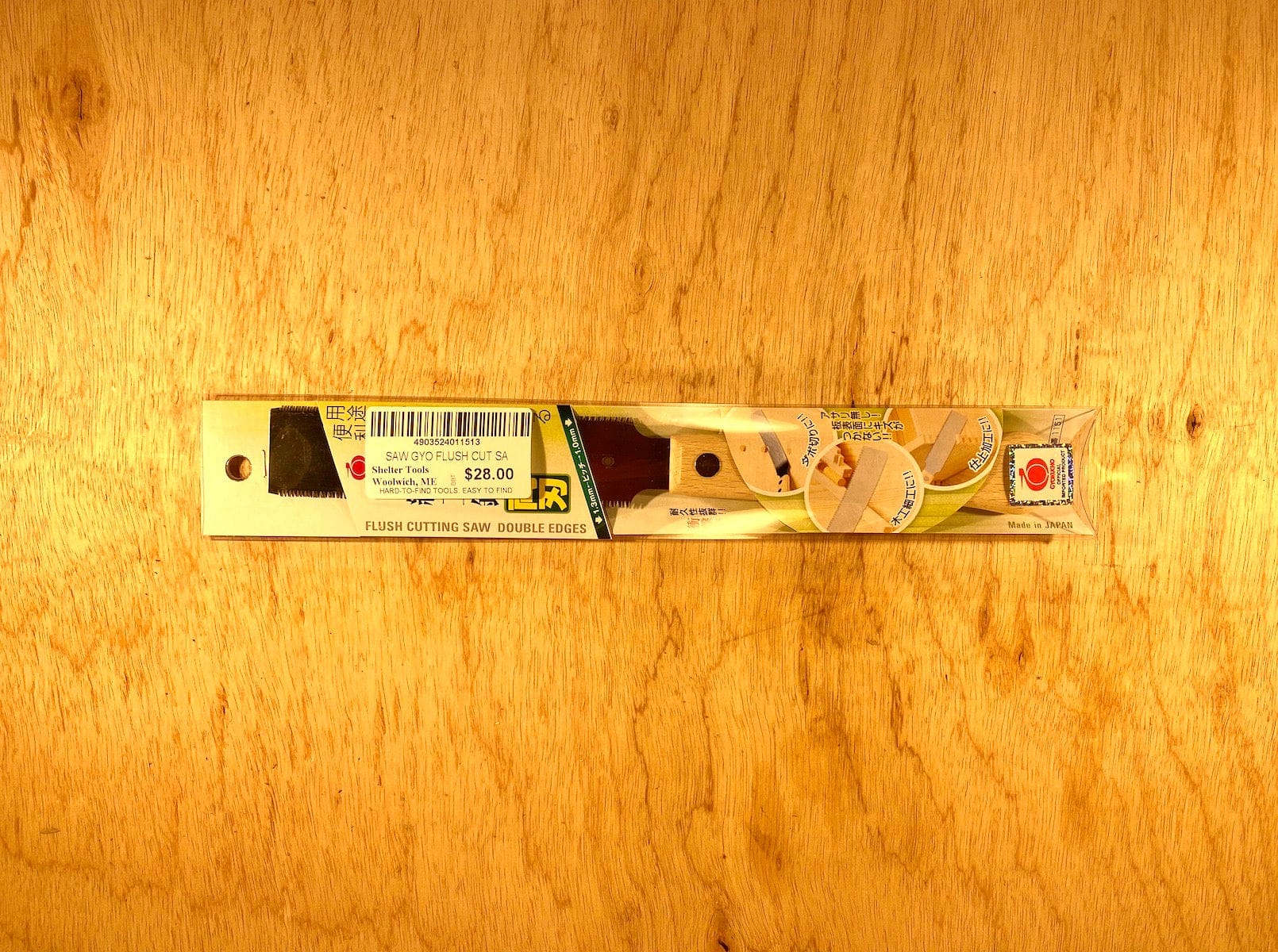 The BBT Gyokucho Flush Cutting Saw Double Edge, priced at $28.00, rests elegantly on a beech wood surface, featuring double edges and cross-cut teeth.