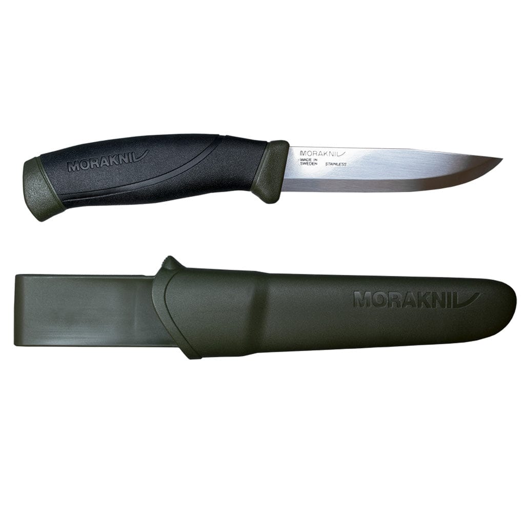 The Companion Adventure Knife by Mora, from Industrial Revolution, is an ergonomic-handled fixed-blade outdoor knife with a sleek black design. It comes with a green sheath, both displaying the "MoraKNIV" branding.
