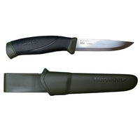 The Companion Adventure Knife by Mora, from Industrial Revolution, is an ergonomic-handled fixed-blade outdoor knife with a sleek black design. It comes with a green sheath, both displaying the "MoraKNIV" branding.