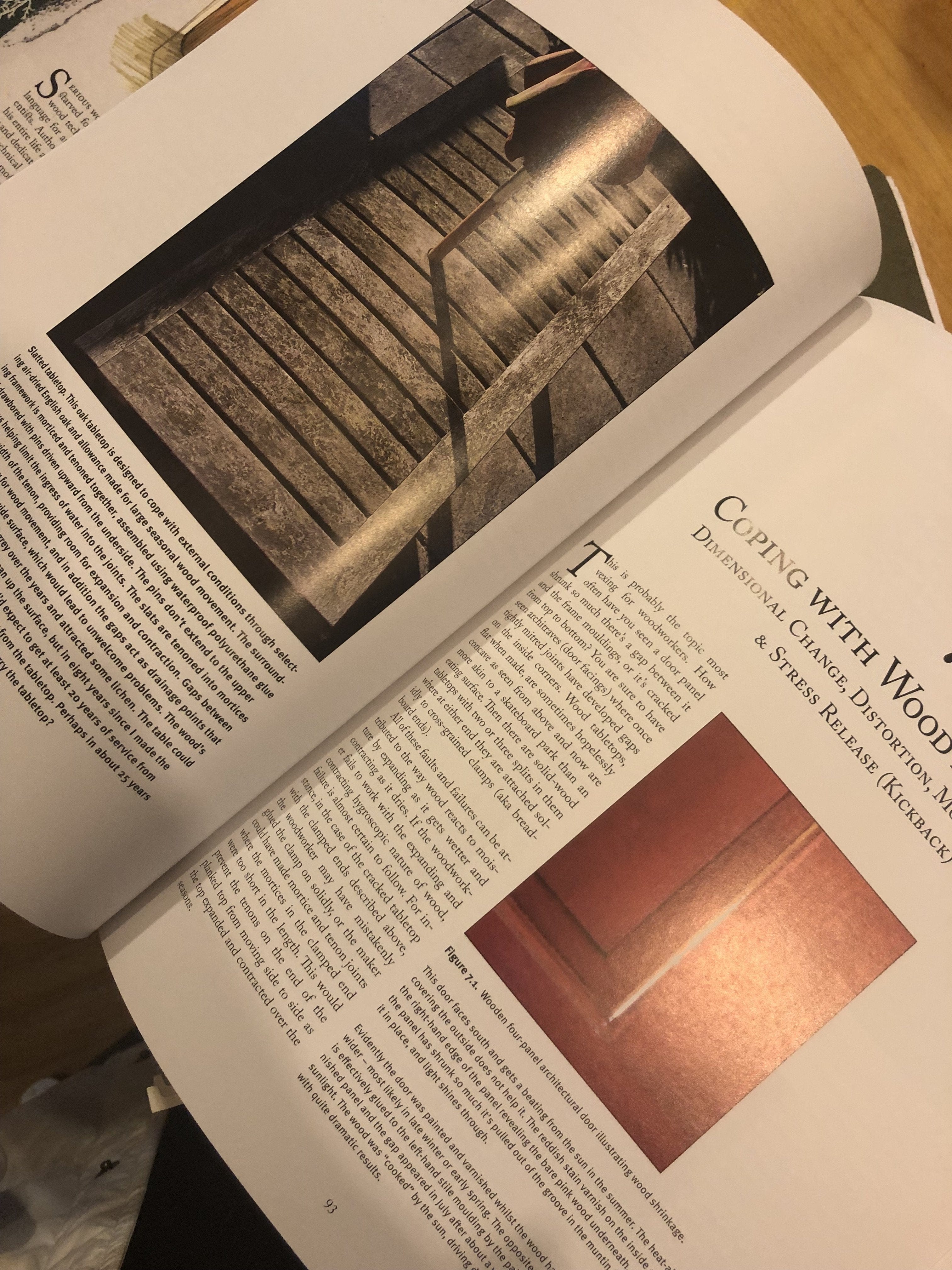 An open magazine shows two articles: one on stone stairs and rails, and another from LAPs Cut & Dried - A Woodworkers Guide to Timber Technology, about wood movement, with a close-up of wood paneling.