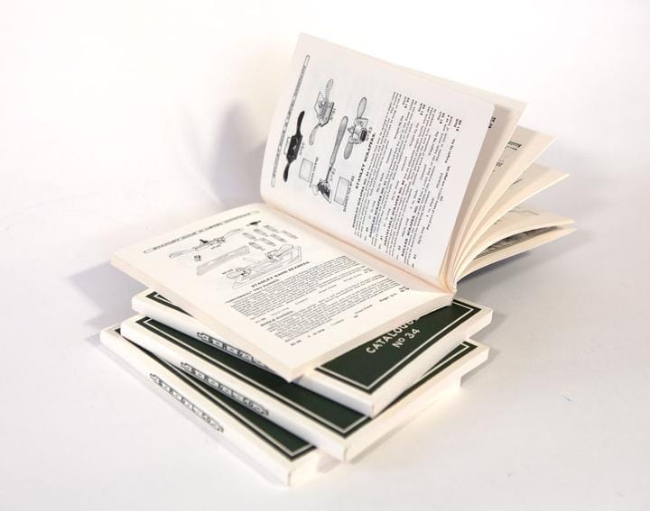 On a white surface, open technical manuals showcase diagrams and text similar to the classic LAP Stanley Tools Catalogue Number 34.