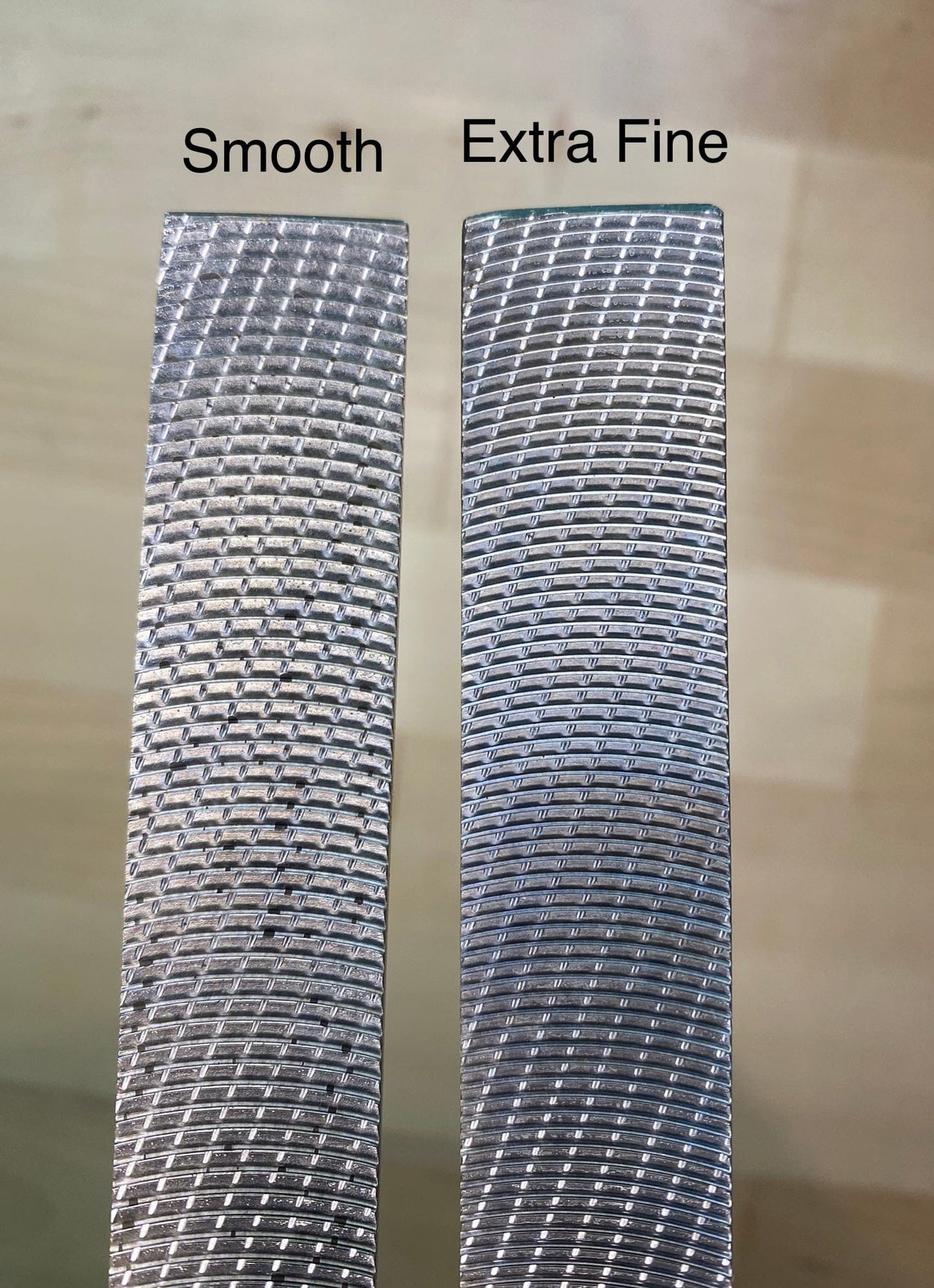 Two MARU Iwasaki Wood Files are placed side by side, labeled "Smooth" and "Extra Fine," each displaying unique grit patterns on their surfaces. These innovative Japanese tools provide a rapid cutting action, distinguishing them in precision woodworking.