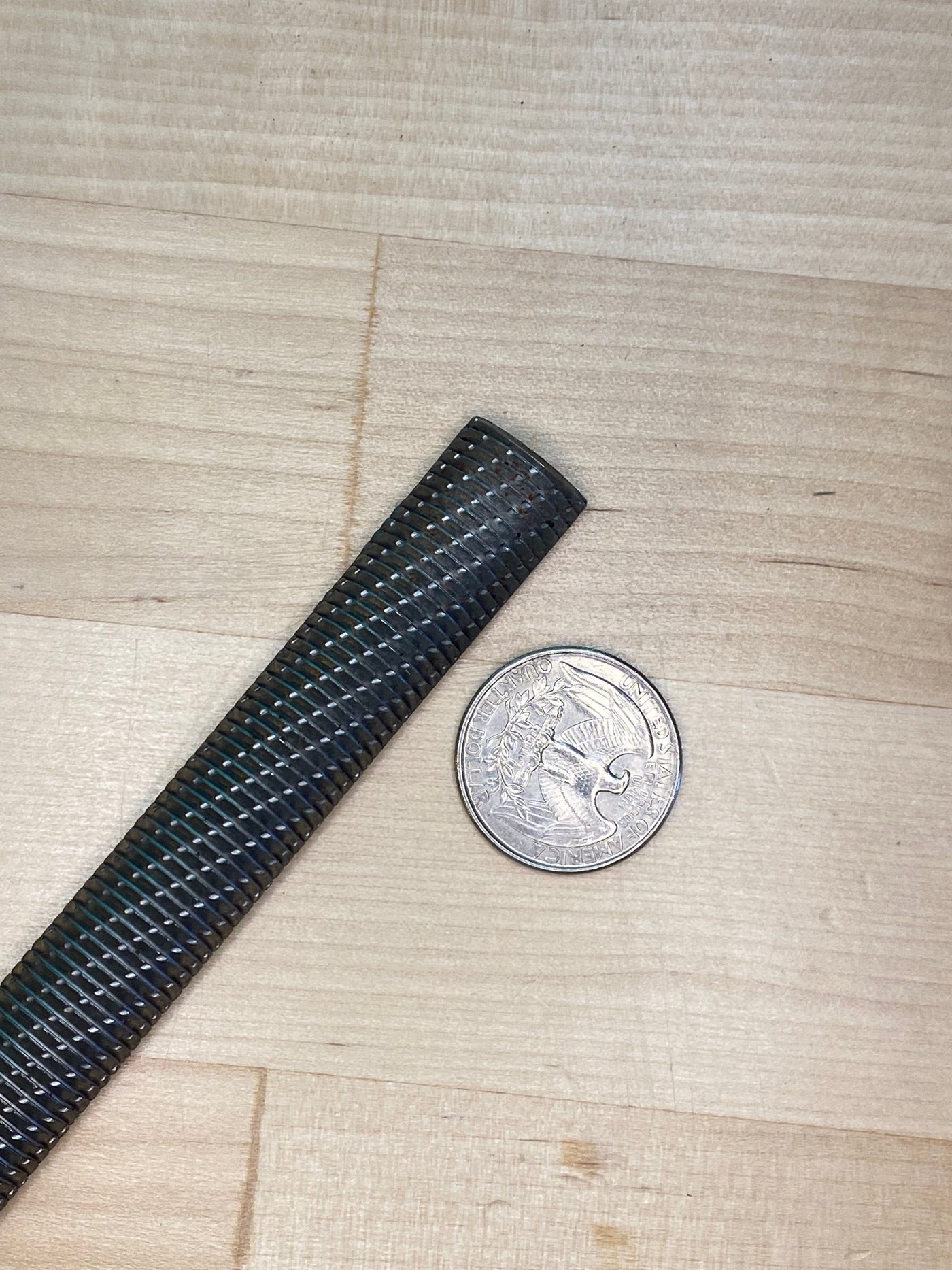 The innovative Iwasaki Wood Files by MARU rest on the wooden surface, next to a quarter—a black braided cable enhances the scene with precision.