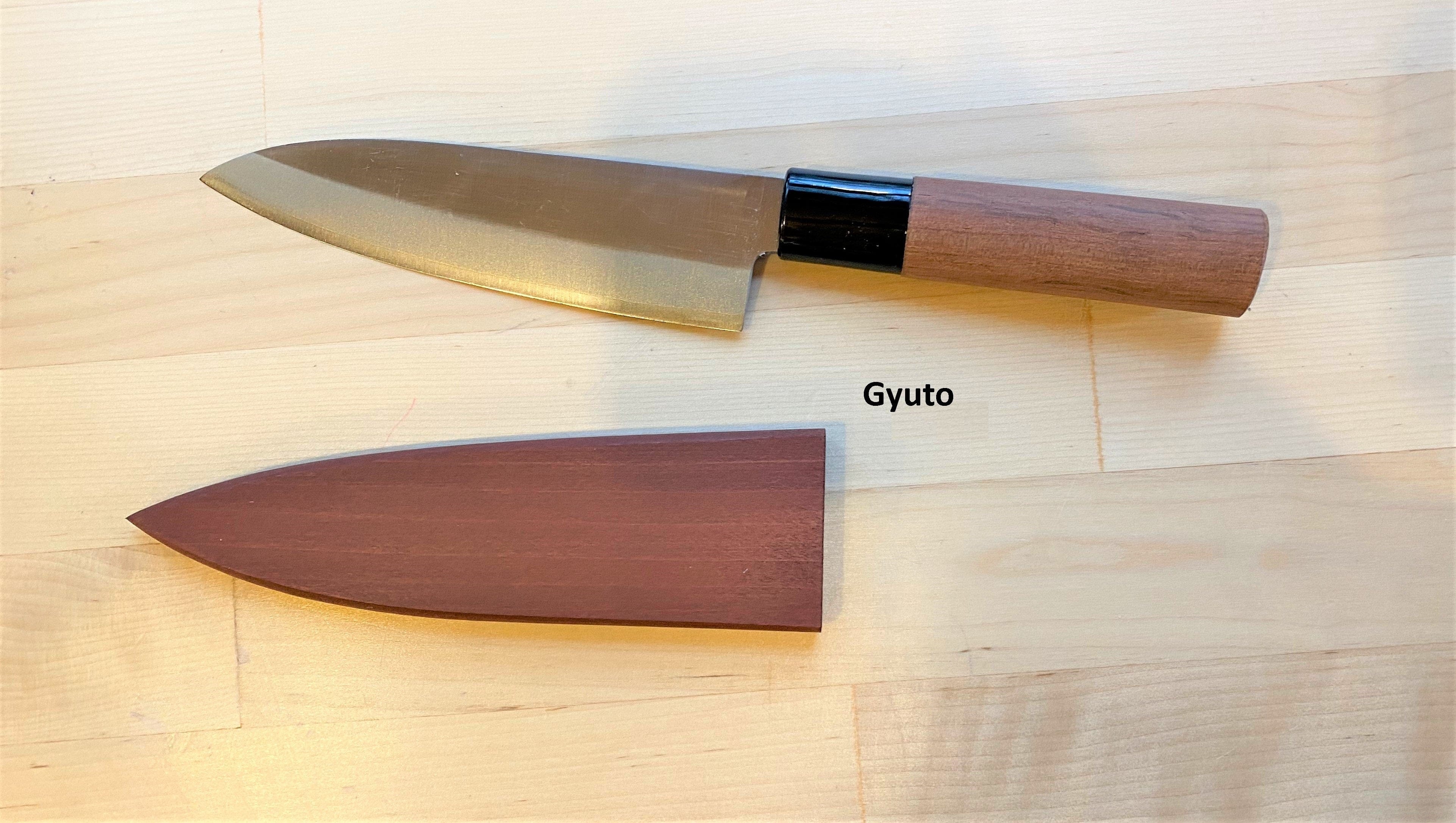 A MARU Japanese Kitchen Knife, a top pick among Japanese kitchen knives, features a wooden handle and blade guard on light wood. The blade guard lies below the knife with “Japanese Kitchen Knife” labeled beside it.