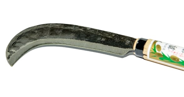 The MARU Sickle Axe is a hand-forged laminated high carbon steel tool with a wooden handle and decorative pattern, ideal for precise razor-sharp cutting.