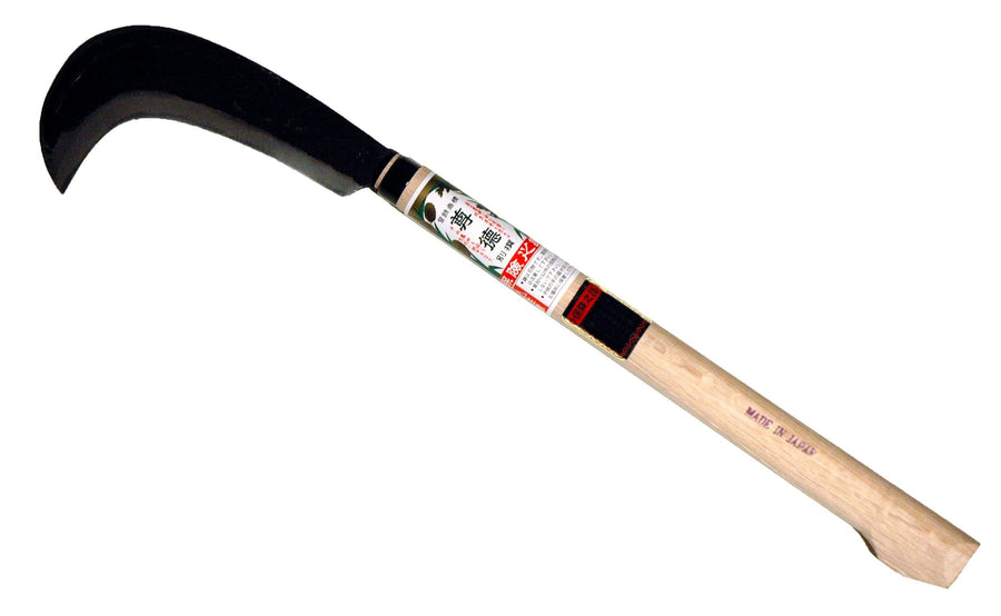 The MARU Sickle Axe features a razor-sharp, curved blade with a wooden handle and label, expertly hand-forged from laminated high carbon steel. Made in Japan.