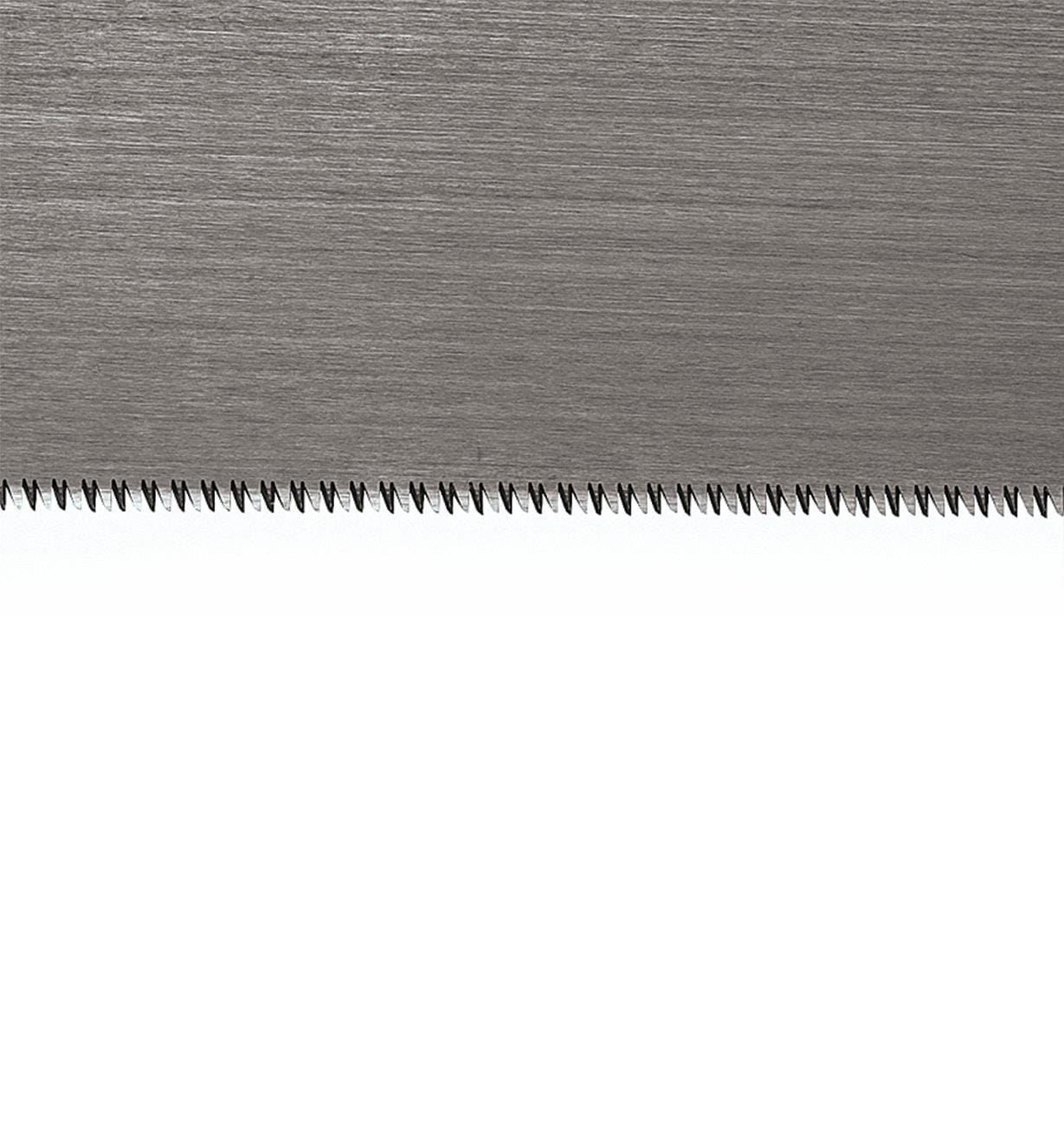 Close-up image of the Fine Wood Working Ryoba by MARU, featuring fine, sharp teeth along the bottom edge, perfect for precise woodworking projects, against a plain background.