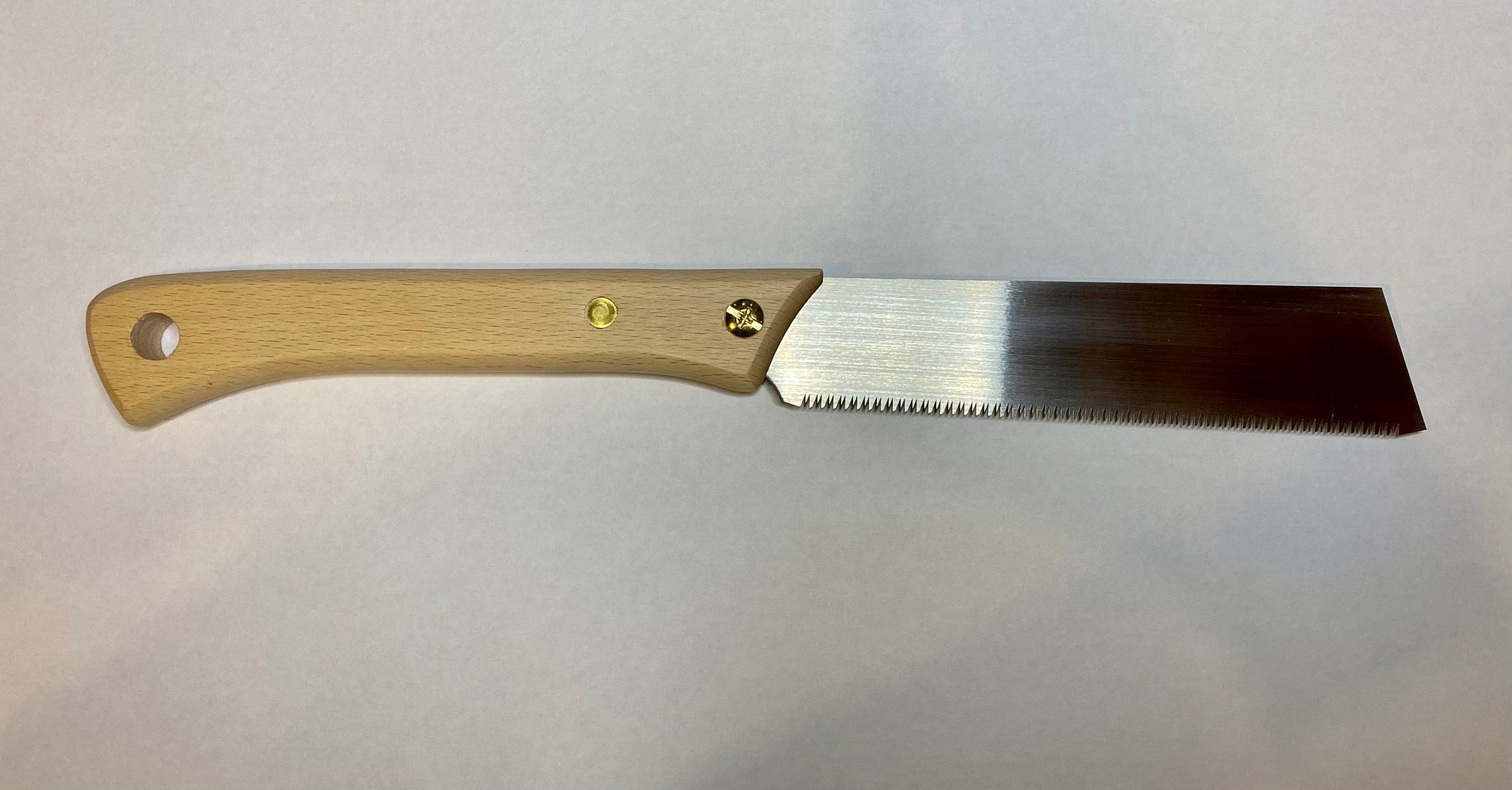 A MARU Japanese Craft Saw, featuring a beech wood handle and a straight, toothed metal blade, is set against a plain white background.