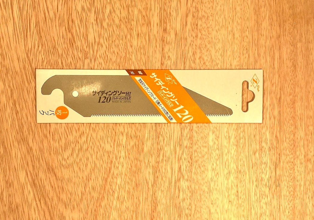 Packaging for a 120mm Siding Saw by Z-Saw from the brand MARU, designed for cutting wood and plaster board, featuring a gray blade with an orange label, displayed on a wooden surface.