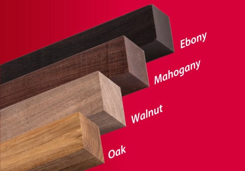 The Z-Saw Hardwood Dozuki 240 from MARU features four finely crafted wooden beams—Ebony, Mahogany, Walnut, and Oak. They are meticulously arranged from top to bottom against a striking red background.