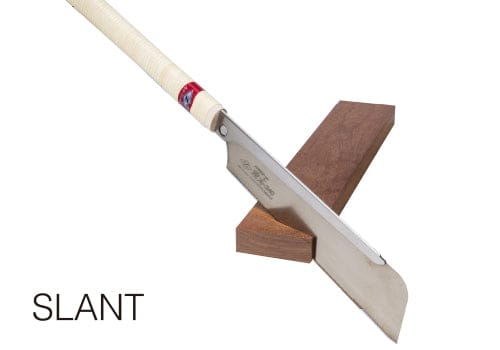 The Z-Saw Hardwood Dozuki 240 by MARU, featuring a cream-wrapped handle, rests on a wooden block. Ideal for fine woodworking and hardwood tasks. The image includes the text "SLANT.