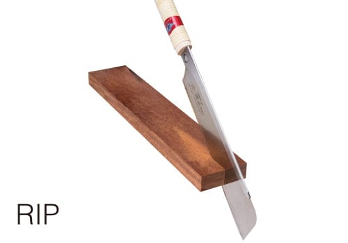 The MARU Z-Saw Hardwood Dozuki 240 effortlessly slices through the wooden plank at an angle, showcasing its precision in fine woodworking. The word "RIP" boldly in the corner highlights its prowess in both hardwood applications and delicate projects alike.