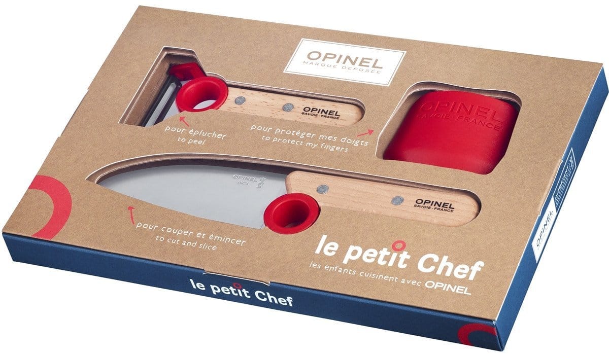 Box containing a children's cooking knife set, branded "Le Petit Chef" by Opinel, which includes an educational kitchen knife with stainless steel blades, a peeler, and a red finger protector.