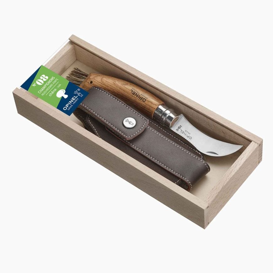 Box with an Opinel Mushroom Knife, featuring a wooden handle and stainless steel blade, plus a brown leather case for mushroom picking adventures.
