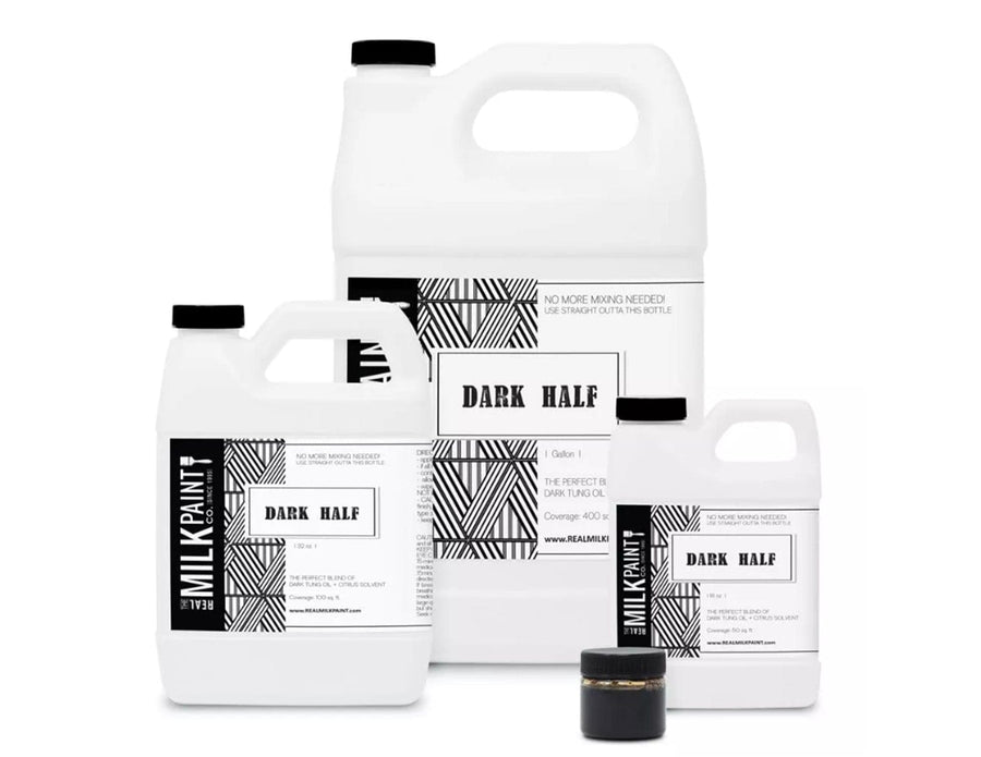 Four containers of "Dark Half Tung Oil" by RMP, ideal for an aged-antique finish, are arranged together, each featuring black and white design elements.