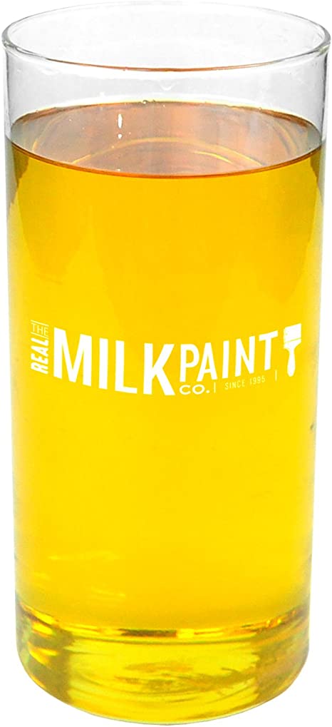 A clear glass filled with a bright yellow liquid, marked "RMP," using Half & Half Tung Oil assures food contact safety.