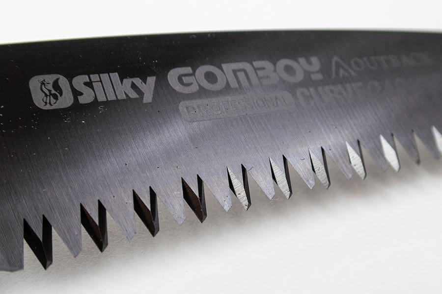 Close-up of the serrated blade on the SHT Silky Outback Folding Saw, highlighting sharp teeth and engraved branding—a durable, high-quality hand saw ideal for outdoor use.