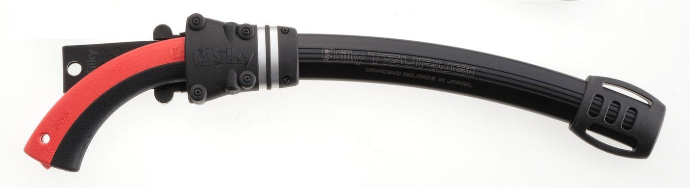 The SHT Tsurugi Arborist Saw 375 mm features a curved blade with impulse hardening, a black handle with red grip, and comes with a ventilated black sheath for durability.