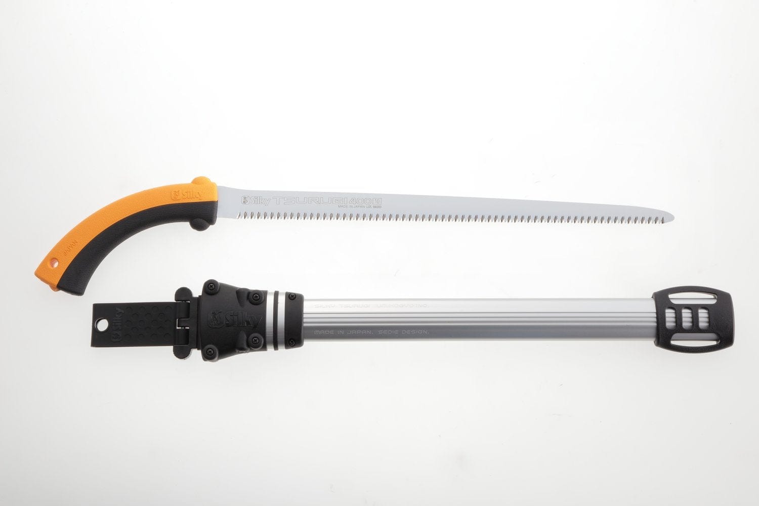 A SHT TSURUGI 400 Medium Teeth 8.5TPI curved pruning saw with an orange handle and long serrated blade rests above its gray sheath, both set on a white background.