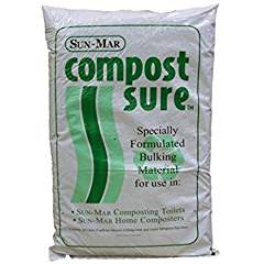 A bag labeled "SUN Compost Sure Composting Toilet Bulking Material" with green text states it is "Specially Formulated Composting Bulking Material for use in Sun-Mar composting toilets and Sun-Mar home composters," designed to enhance rapid decomposition.