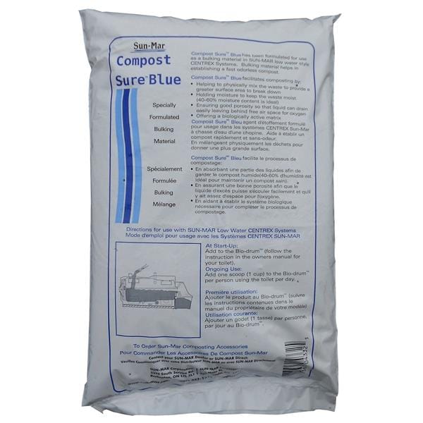 A white bag labeled "Sun-Mar Compost Sure Composting Toilet Bulking Material" with instructions and product details printed on the front, intended for rapid decomposition in a Sun-Mar composting toilet.
