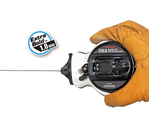 Hand in a brown glove holding a black and white Tajima Chalk-Rite Gear Drive II chalk line reel with a thin premium chalk line extended. Text on the image reads “Extra Bold 1.0 mm” featuring TAJ's Gear Drive II technology.