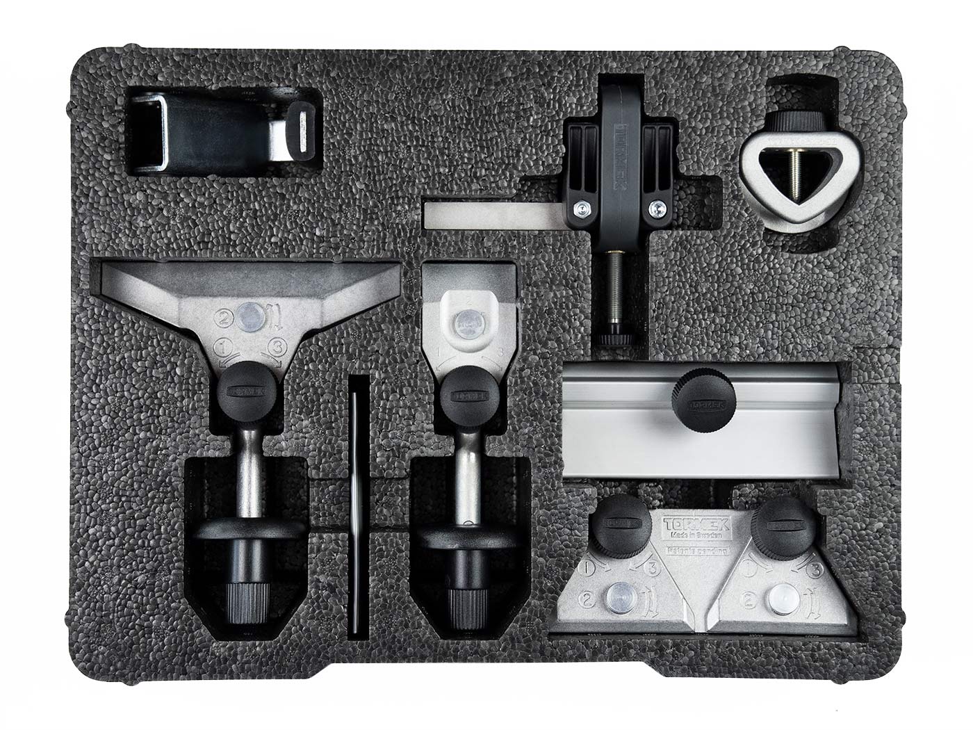 The TOR Tormek Hand Tool Kit is a black case featuring assorted metal and plastic automotive glass repair tools—such as clamps, mounts, and applicators—each organized in their own slots.