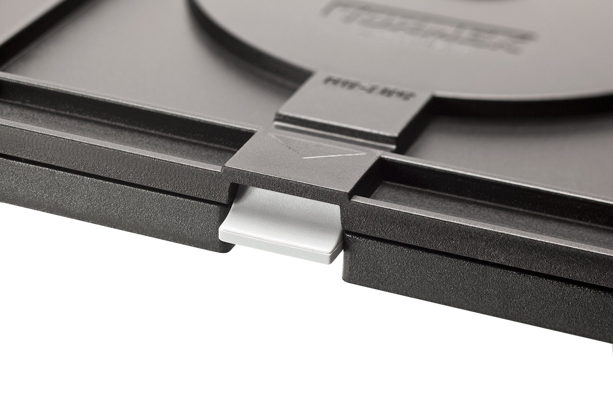 Close-up of the Tormek Rotating Base by TOR, featuring a black plastic latch mechanism with a rectangular tab on a textured surface for precision adjustments.