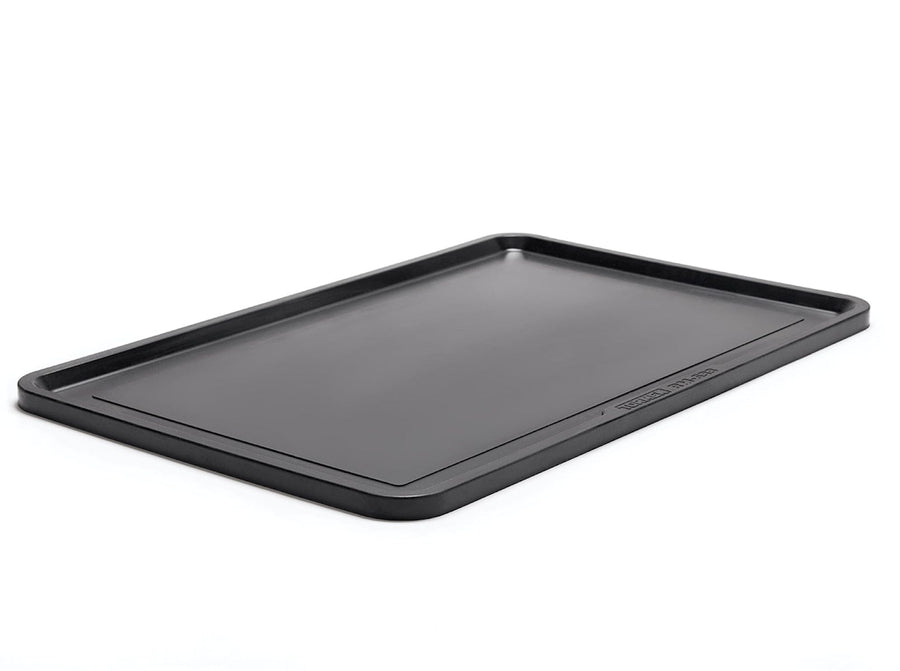 The Tormek Rubber Work Mat by TOR is a rectangular black tray with raised edges, designed with a non-slip surface for stability, and is shown lying flat on a white background.