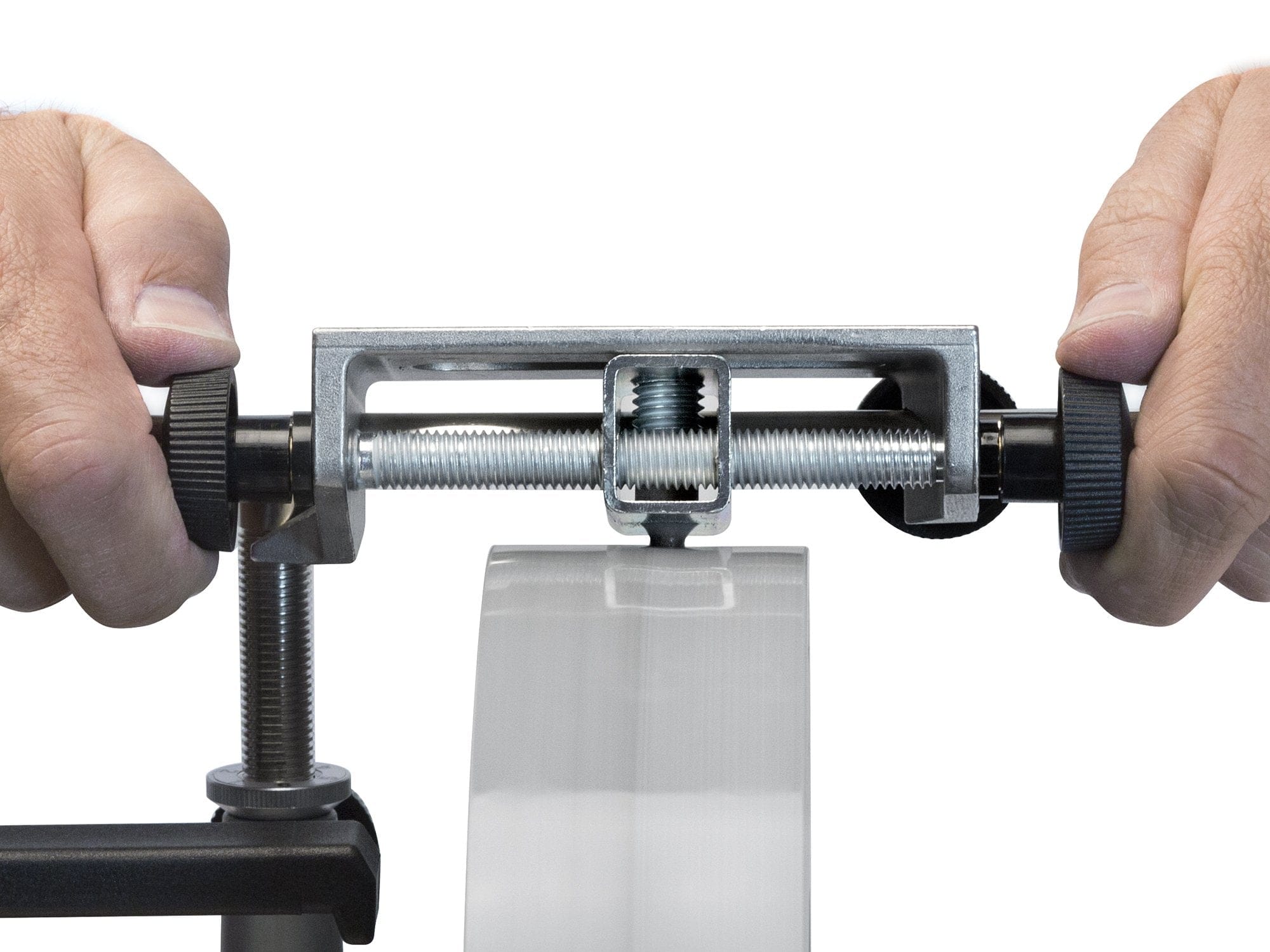 Close-up of hands using a TOR Tormek Truing Tool with screws to measure or adjust a cylindrical object, ensuring controlled cutting depth.