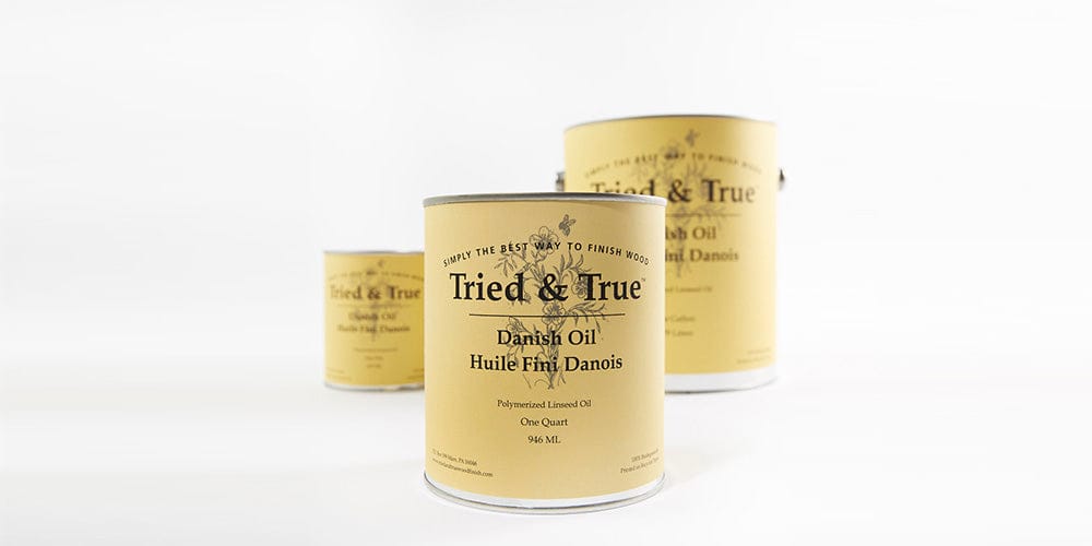 Three cans of TRD Tried & True Danish Oil Finish, ideal for enriching wood stains, are showcased in different sizes against a spotless white backdrop.